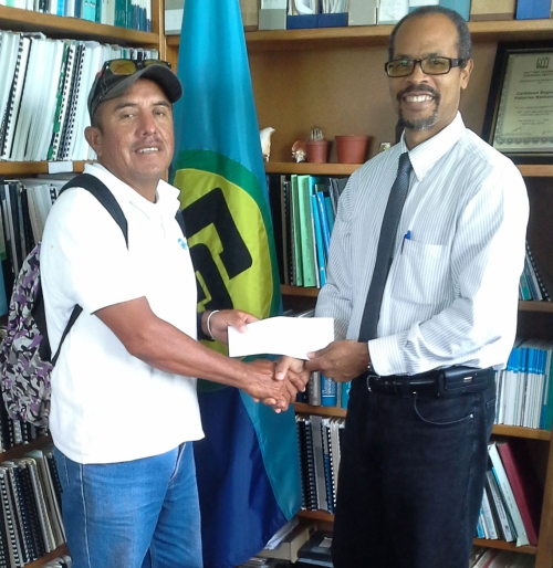 CRFM Executive Director, Milton Haughton, presents reward to Outstanding Fisher of the Year, Cesar Muñoz