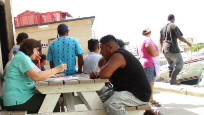 Claudia Stella Beltr&aacute;n Turriago, economic consultant, interviewing fishers at Northern Fishermen's Cooperative in Belize City, Belize